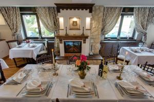 a dining room with tables and chairs and a fireplace at Casa Din Bran - Inn Center in Bran