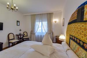 a bedroom with a large bed and a window at Casa Din Bran - Inn Center in Bran