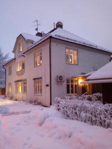 a house covered in snow in the yard at Gustafs Logi in Borlänge