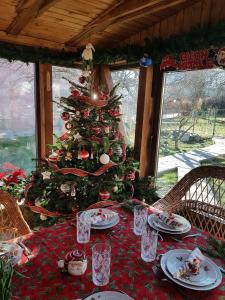 a christmas table with a christmas tree in a house at Casa Mara in Breaza