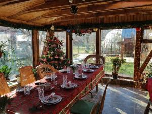 a long table with a christmas tree in a room at Casa Mara in Breaza