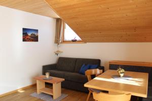 a living room with a couch and a table at Haus Waldruhe in San Candido