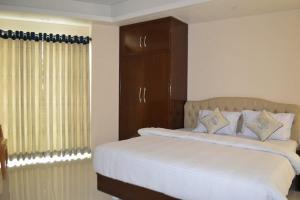 a bedroom with two beds and a window at Exotica Sampan in Cox's Bazar +9 photos