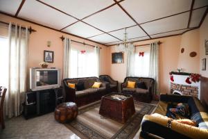 a living room with a couch and a tv at Pedro View Homestay in Nuwara Eliya