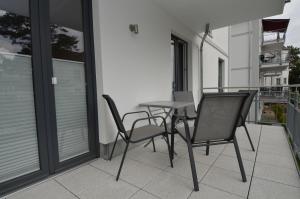 a table and two chairs on a balcony at Residenz Margarete - Apt. 2.3 in Binz