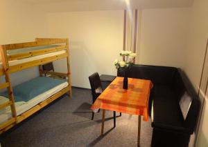 a small room with a table and a bunk bed at Pension Haus Rodenstein in Altenbrak