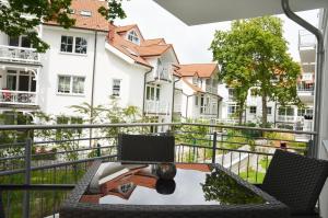 a balcony with a table and a laptop on it at Residenz Margarete - Apt. 2.5 in Binz