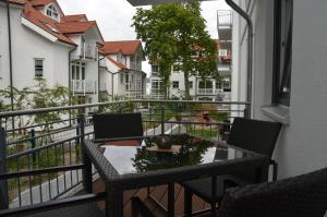 a balcony with a table and chairs on a balcony at Residenz Margarete - Apt. 2.5 in Binz
