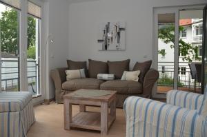a living room with a couch and a table at Residenz Margarete - Apt. 2.5 in Binz