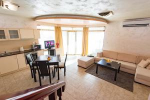 a living room with a couch and a table at Forest Nook Villas in Pamporovo