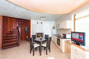 a kitchen and dining room with a table and chairs at Forest Nook Villas in Pamporovo