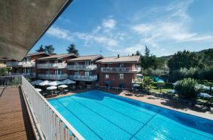 een balkon met uitzicht op het zwembad van een resort bij Residence Villa Rosa in Garda