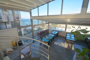 a balcony of a building with tables and chairs at Istankoy Hotel in Kusadası