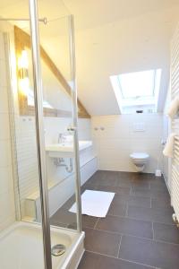a bathroom with a shower and a sink and a toilet at Auszeit in Obermaiselstein +54 photos