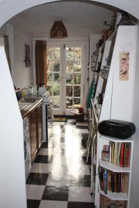 a kitchen with a black and white checkered floor at Whitstable Tree House Retreat in Whitstable
