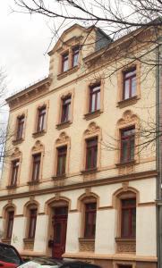 a large building with red doors and windows at Ferienwohnung Tiffy in Chemnitz