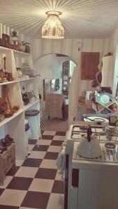 a kitchen with a black and white checkered floor at Whitstable Tree House Retreat in Whitstable