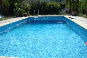 a large swimming pool with blue water at l'Oulibo in Villeneuve-les-Corbières +8 photos