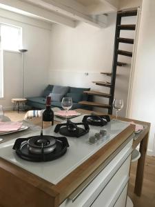 a kitchen with a counter top with a bottle of wine at Mooi Genieten in Middelburg