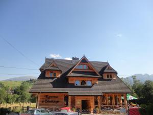 a house with a gambrel roof on top of it at Willa u Słodkiego in Zakopane