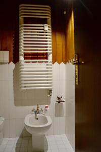 a bathroom with a toilet and a sink at White Attic in Breuil-Cervinia