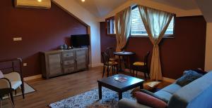 a living room with a couch and a table at Studio Maison 3 Kapana in Plovdiv