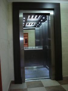 a elevator in a building with a glass door at Hotel Torres del Sol in Merlo