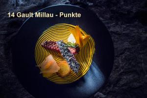 a plate of food on a black plate at Hotel Schönegg in Wengen +46 photos