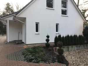 a white house with a courtyard in front of it at Schönwalde B in Siedlung Schönwalde