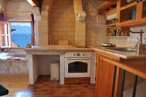 a kitchen with a stove and a sink and a counter at Apartment Korcula Town in Korčula +34 photos
