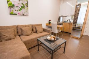 a living room with a couch and a table at Luxury Apartments on Central Avenue in Tbilisi City