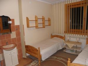 willa Relaks في كوشتيليسكا: غرفة نوم صغيرة بها سرير ومغسلة