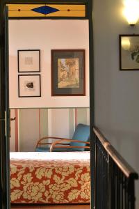 a bedroom with a bed and a blue chair at Il Cortile - Casa d'Artista in Casalzuigno