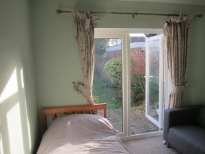 a bedroom with a bed and a sliding glass door at No 9 in Bognor Regis