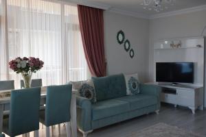 a living room with a couch and a table with a television at Trabzon Sea Palace in Trabzon