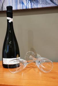 a bottle of wine and two wine glasses on a table at RHOMENJOY Suite Vatican in Rome