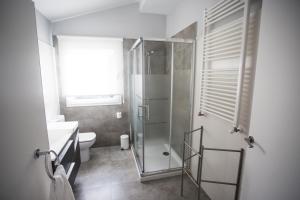 a bathroom with a glass shower and a toilet at Casa Rural Arraigorri in Hernani +22 photos