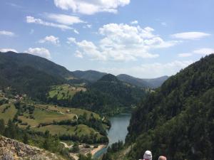 two people standing on top of a mountain overlooking a river at Apartment Vila Fila in Mitrovac
