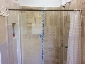 a bathroom with a shower with a shower curtain at Casa del Arquitecto in Cancún +46 photos