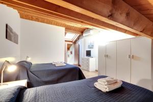 a bedroom with two beds with towels on them at Lagoon Apartment in Venice