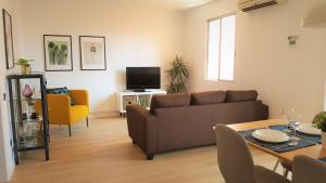 a living room with a couch and a table at Caputxins Apartment in Tarragona