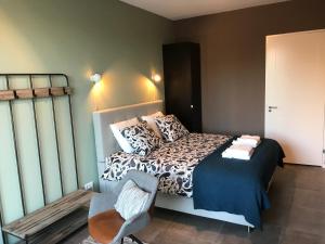 a bedroom with a bed and a desk at De Kade in Groningen