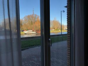 
a view through a window of a city street at De Kade in Groningen

