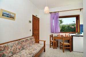 a living room with a couch and a table at San Antonio Apartments in Kolymvari