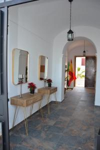 a hallway with two mirrors and two tables at Complejo Rural Rincón del Paraíso in Valencia del Mombuey