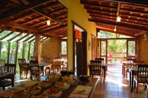 a dining room with a table with food on it at Pássaro de Fogo in Santo Antônio do Pinhal