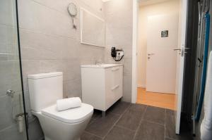 a bathroom with a white toilet and a sink at Los Rodeos Luxury Vivienda Vacacional in La Laguna +37 photos