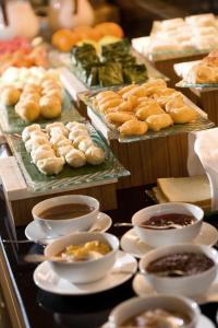 a buffet filled with different types of pastries and dips at Hotel Santika Bangka in Pangkal Pinang