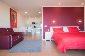 a red bedroom with a bed and a couch at Los Rodeos Luxury Vivienda Vacacional in La Laguna