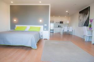a bedroom with a bed and a living room at Los Rodeos Luxury Vivienda Vacacional in La Laguna